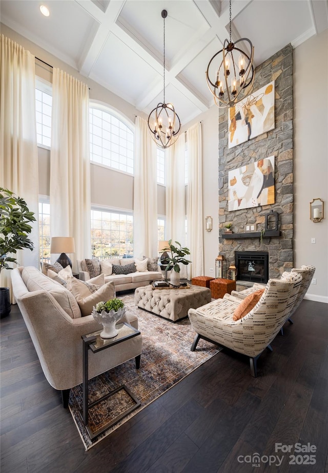 living room with an inviting chandelier, hardwood / wood-style flooring, beam ceiling, and coffered ceiling