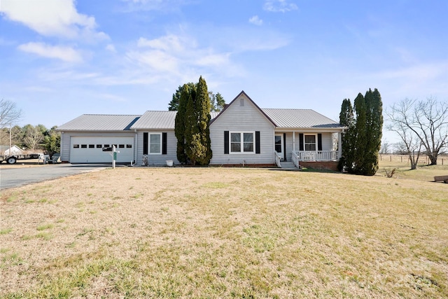 ranch-style house with a garage, covered porch, and a front yard