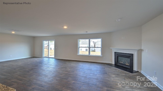 unfurnished living room with dark wood-type flooring