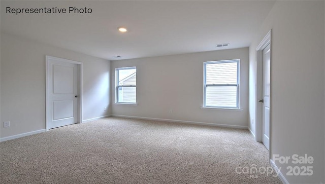 unfurnished room with light colored carpet