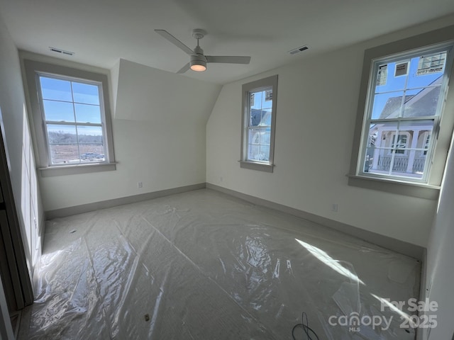 spare room featuring vaulted ceiling and ceiling fan