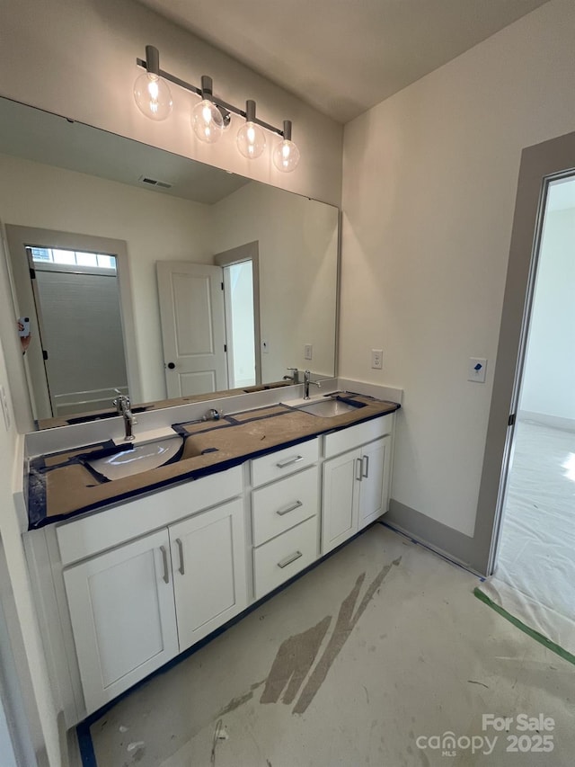 bathroom featuring vanity and concrete flooring