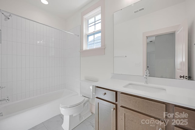 bathroom with marble finish floor, visible vents, toilet, washtub / shower combination, and vanity