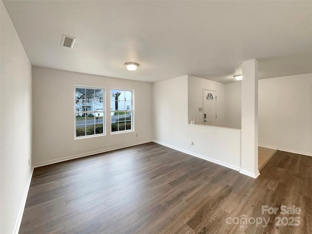 empty room featuring dark wood-type flooring