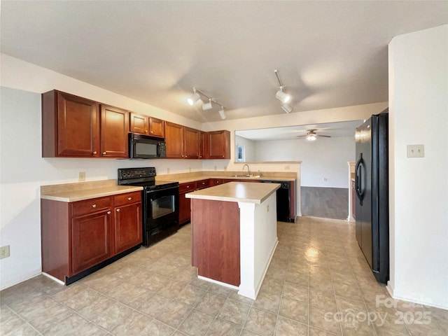 kitchen featuring sink, black appliances, ceiling fan, and a kitchen island