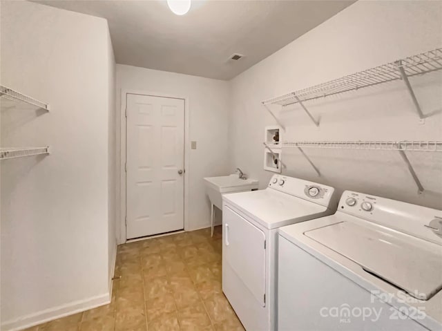 laundry room featuring washing machine and dryer and sink