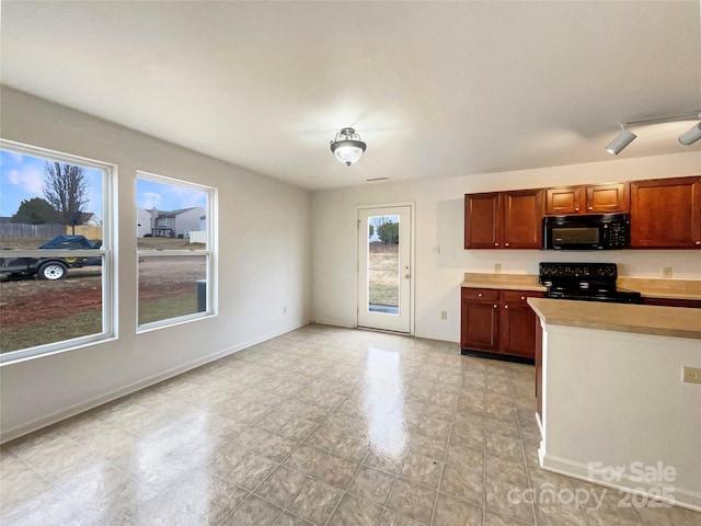 kitchen featuring a healthy amount of sunlight and black appliances