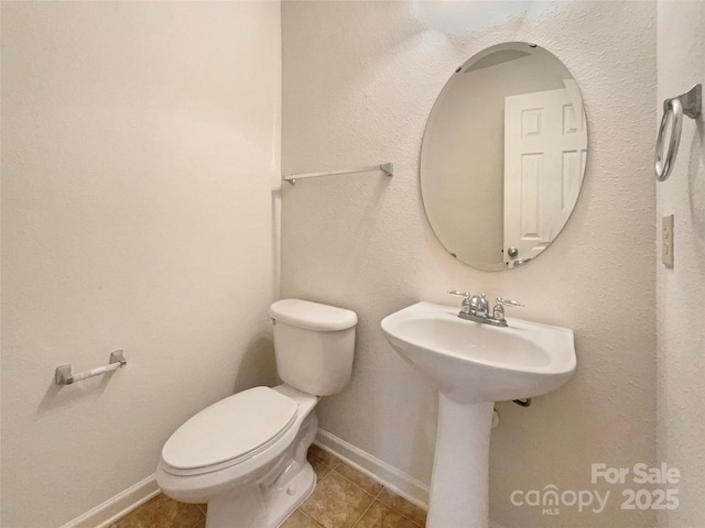 bathroom with sink, tile patterned floors, and toilet