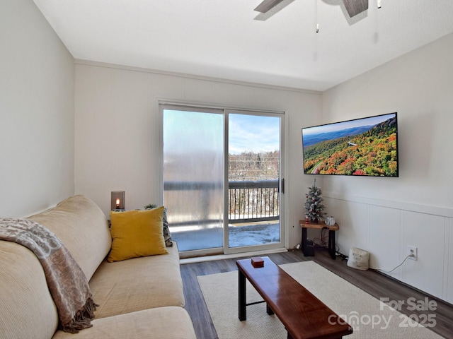 living room with ceiling fan and dark hardwood / wood-style flooring