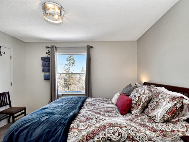 bedroom with a textured ceiling and carpet flooring