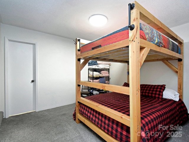 carpeted bedroom with a textured ceiling