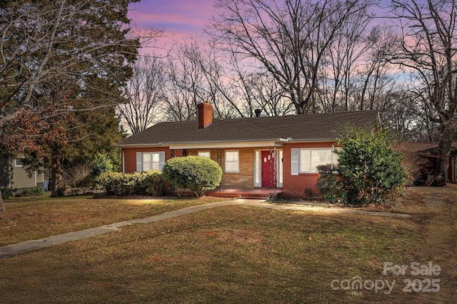 ranch-style house featuring a lawn