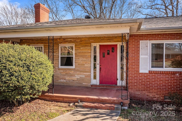 view of exterior entry with a porch