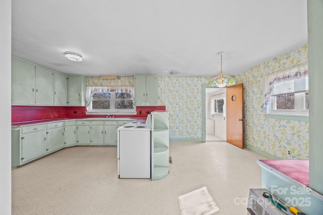 kitchen with sink, hanging light fixtures, and white range with electric stovetop