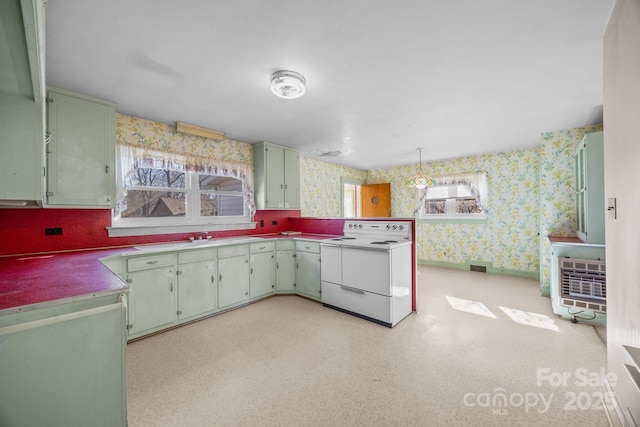 kitchen featuring green cabinets, decorative light fixtures, and white electric range oven