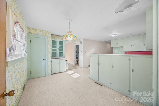 kitchen featuring hanging light fixtures and kitchen peninsula