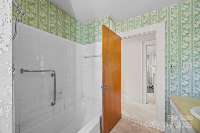 bathroom featuring washtub / shower combination and vanity