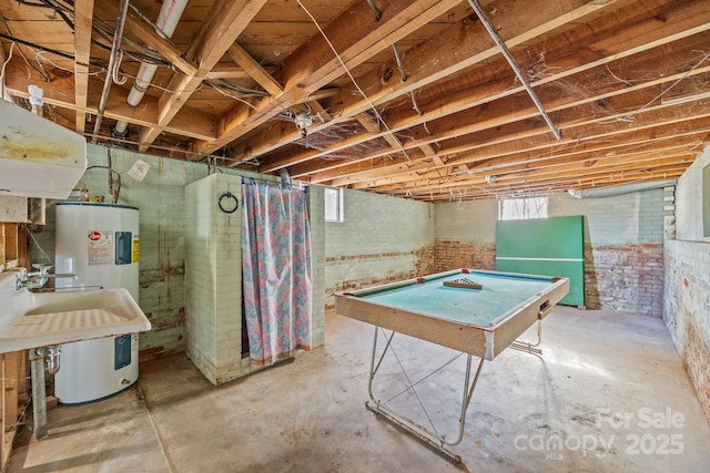 basement featuring pool table and water heater