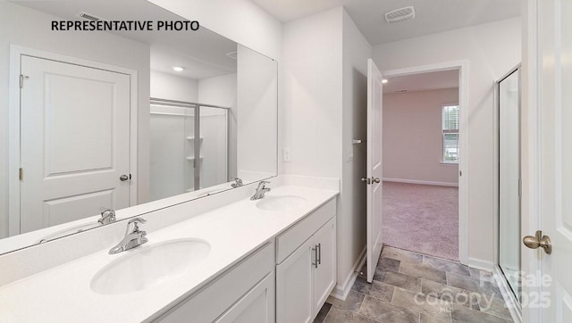 bathroom featuring vanity and a shower with door