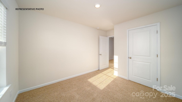 unfurnished bedroom with light carpet