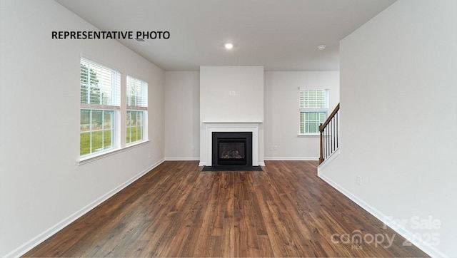 unfurnished living room featuring dark hardwood / wood-style flooring