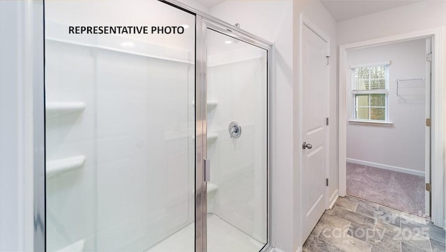 bathroom featuring a shower with shower door