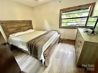 bedroom with hardwood / wood-style flooring and ceiling fan