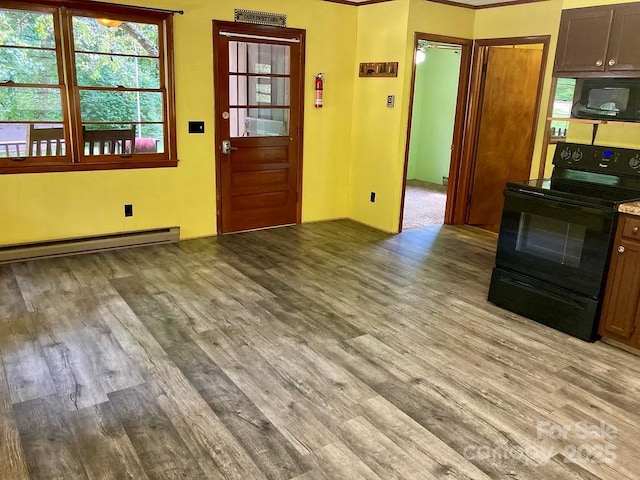 interior space with baseboard heating and light hardwood / wood-style flooring