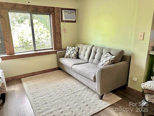 living room featuring wood-type flooring and a wall unit AC