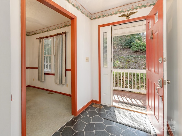 view of carpeted foyer