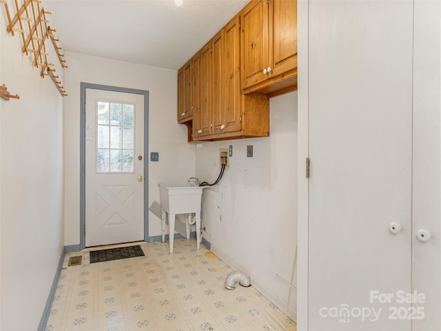 laundry area featuring cabinets, washer hookup, and sink