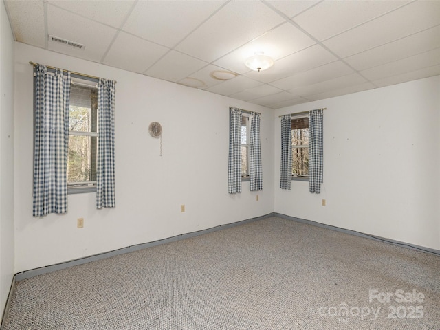 unfurnished room featuring a paneled ceiling