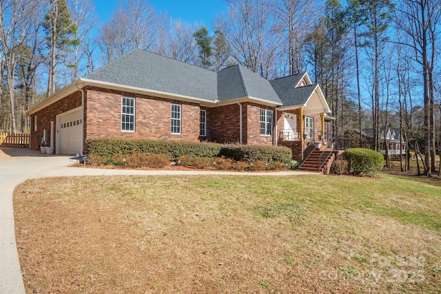 view of front of home with a garage, covered porch, and a front yard