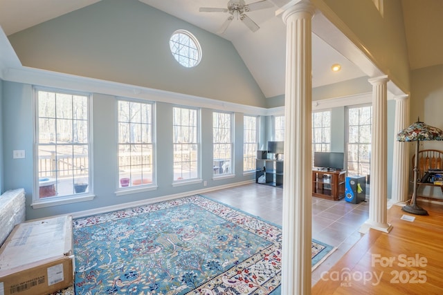 interior space with decorative columns, lofted ceiling, a wealth of natural light, and ceiling fan