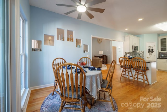 dining area featuring ceiling fan and light wood-type flooring