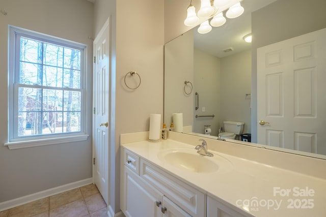 bathroom featuring vanity, tile patterned floors, toilet, and a healthy amount of sunlight