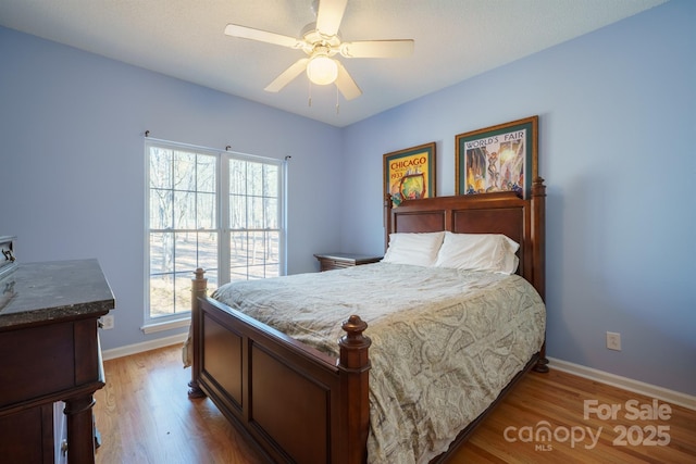 bedroom with hardwood / wood-style flooring and ceiling fan