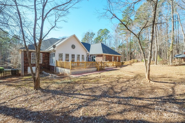 back of house with a deck