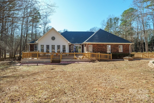 rear view of property with a yard and a deck