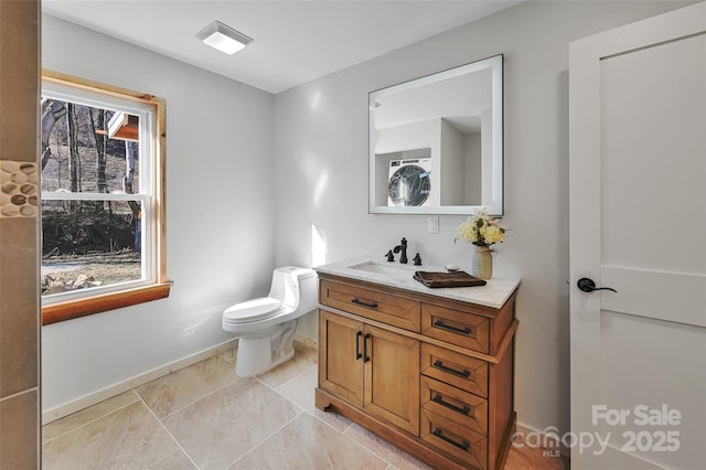 bathroom featuring vanity, tile patterned floors, and toilet