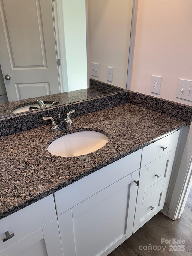 bathroom with vanity and wood finished floors