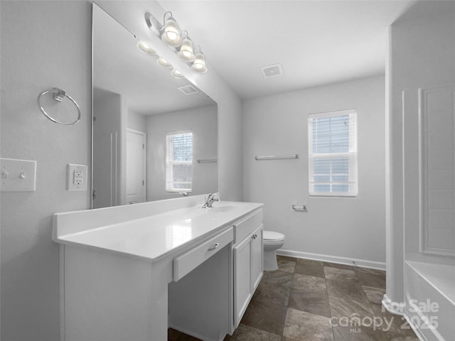 bathroom featuring vanity and toilet