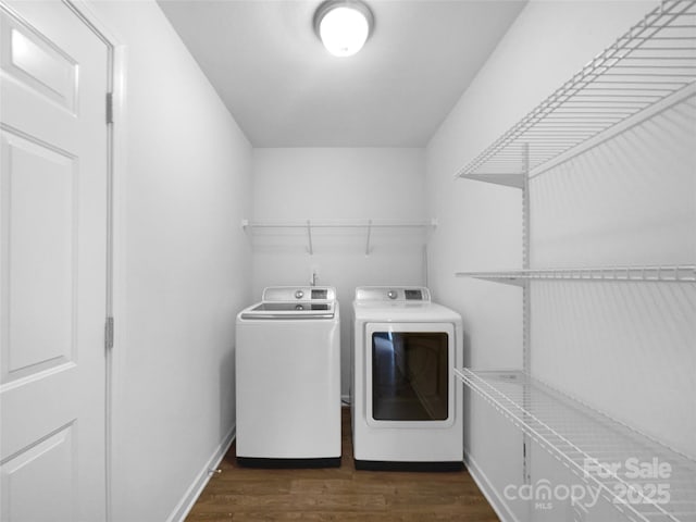 laundry room featuring washing machine and dryer and dark hardwood / wood-style floors