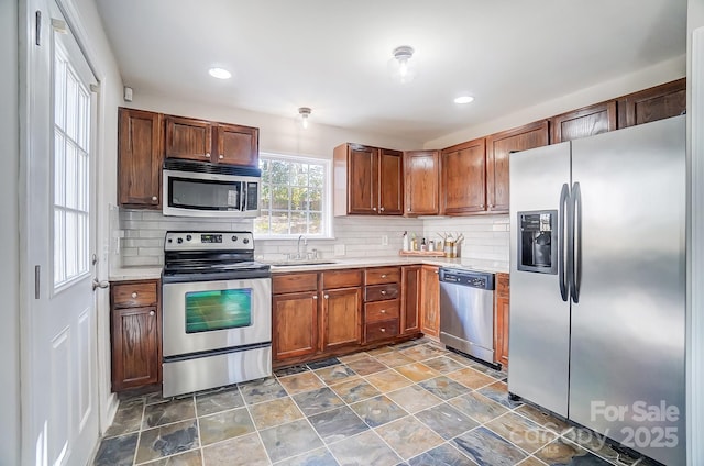 kitchen featuring tasteful backsplash, sink, and appliances with stainless steel finishes