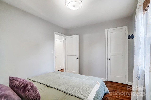 bedroom featuring dark hardwood / wood-style flooring