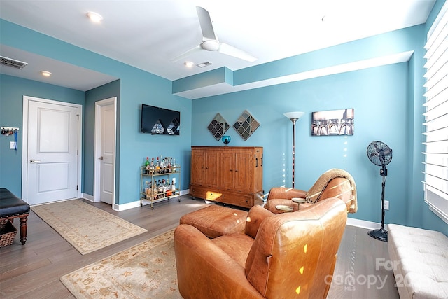 living room with hardwood / wood-style flooring and ceiling fan