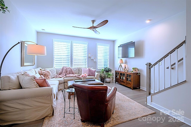 living room with ceiling fan and light hardwood / wood-style floors