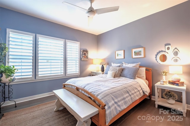 bedroom with ceiling fan and dark hardwood / wood-style flooring