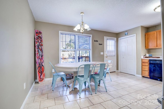 tiled dining area featuring a notable chandelier and a textured ceiling