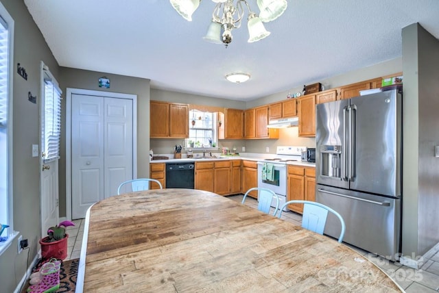 kitchen with pendant lighting, white electric range, dishwasher, high end fridge, and light tile patterned flooring